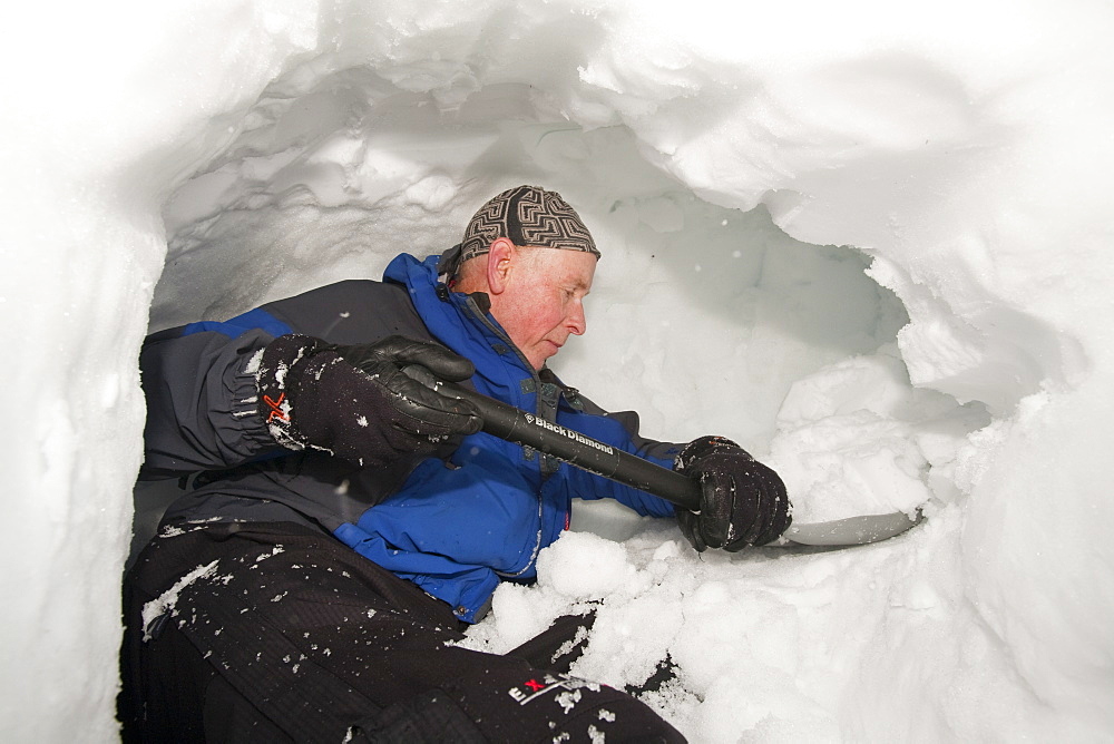 A group of mountaineers building snow holes on Cairngorm in the Cairngorm National Park in Scotland, United Kingdom, Europe