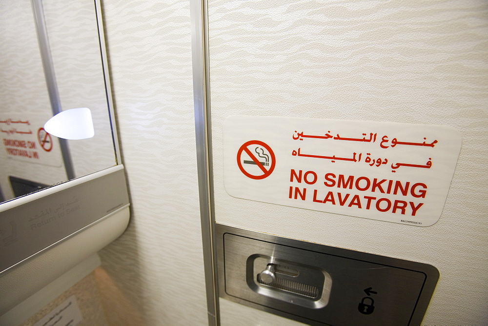 A no smoking sign in an airplane toilet