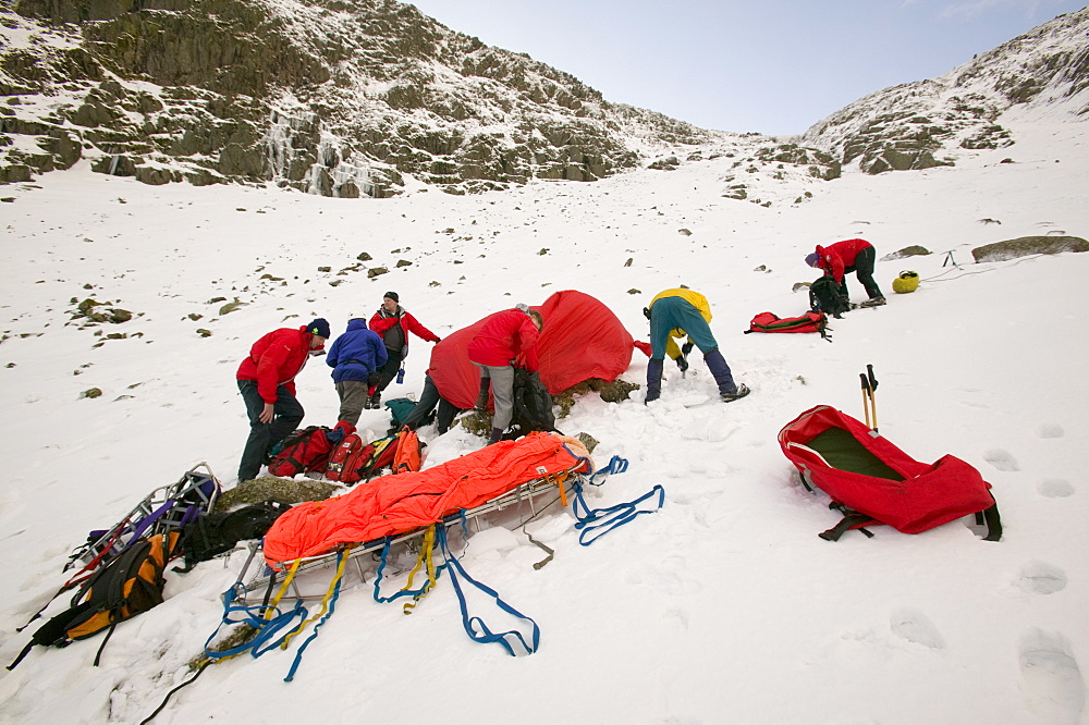 Mountain rescue team members rescue a seriously injured women from Red Screes who had fallen 300 feet in the snow, Lake District, Cumbria, England, United Kingdom, Europe