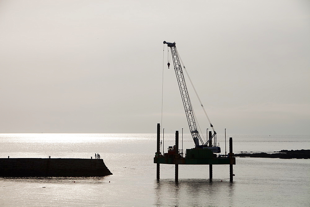 A crane on a platform off Sennen Cove Harbour in Cornwall, England, United Kingdom, Europe