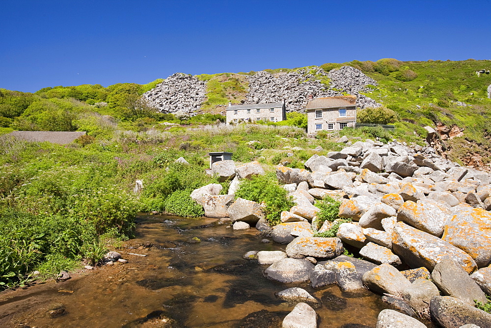 Houses at Lamorna Cove, overshadowed by boulders from an old quarry, Cornwall, England, United Kingdom, Europe