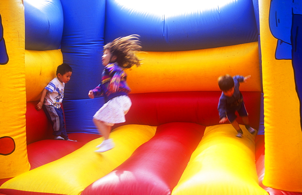 Children playing on a bouncy castle