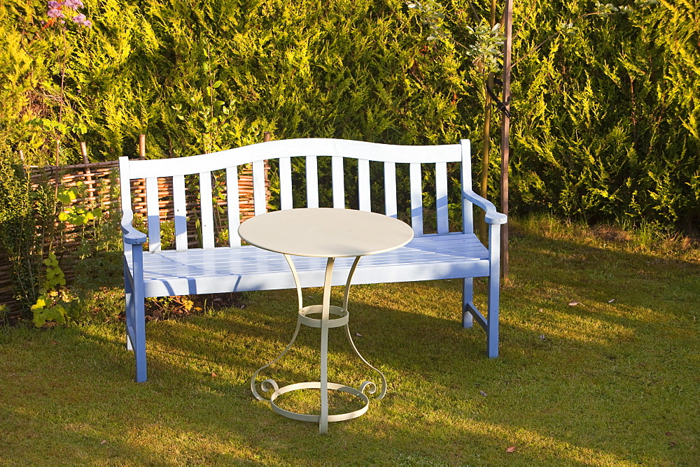 A garden bench and table on a garden lawn, Ambleside, Cumbria, England, United Kingdom, Europe