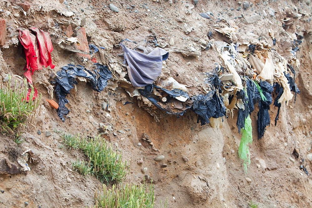 Buried rubbish revealed by coastal erosion on the west coast of Walney Island, Cumbria, England, United Kingdom, Europe