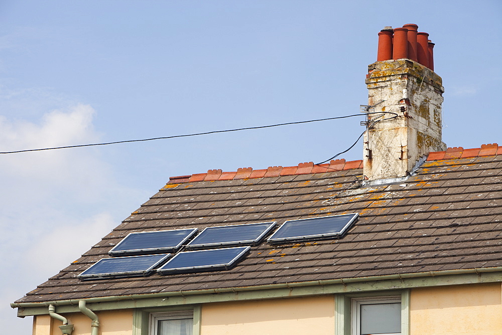 Solar water heaters on a house roof in Barrow in Furness, Cumbria, England, United Kingdom, Europe