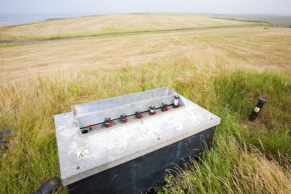 An old rubbish tip where the methane escaping from the decomposing rubbish is being captured and burnt, Walney Island, Cumbria, England, United Kingdom, Europe