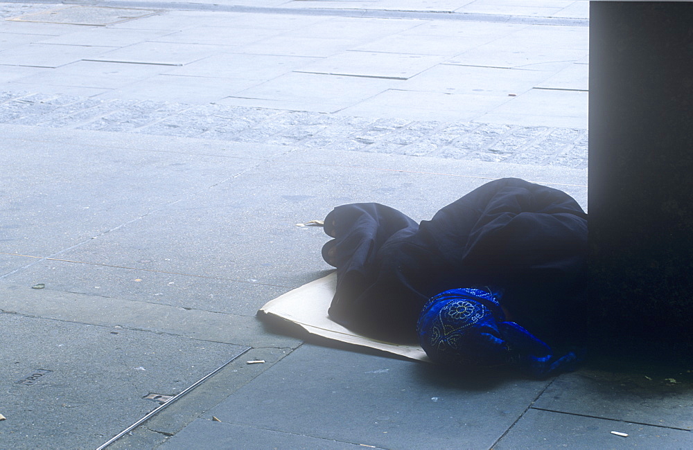 A homeless woman sleeping on a London street, England, United Kingdom, Europe