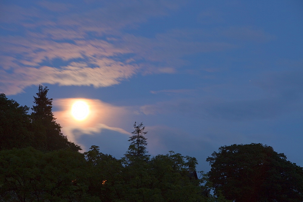 Moon behind thin cloud over Ambleside, Lake District, Cumbria, England, United Kingdom, Europe