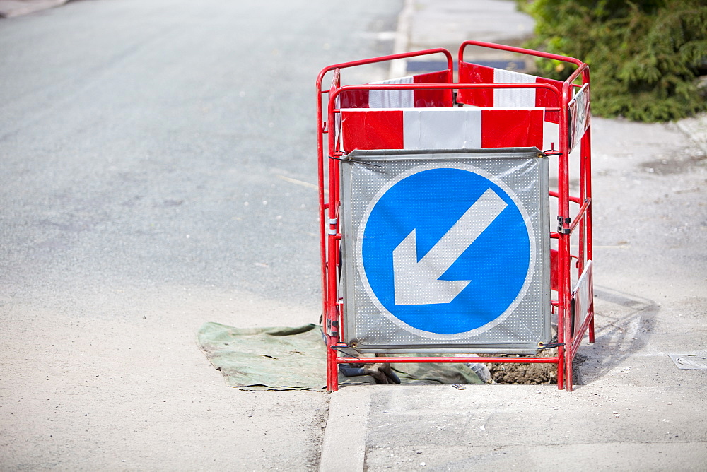 A barrier surrounding a hole in the pavement, Ambleside, Lake District, Cumbria, England, United Kingdom, Europe