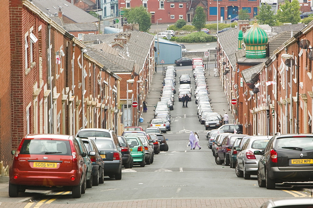 Cars parked on a street in the Asian area of Blackburn, Lancashire, England, United Kingdom, Europe