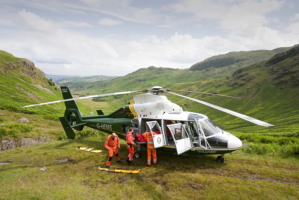 Paramedics from the Great North Air Ambulance and members of Langdale/Ambleside Mountain Rescue Team evacuate an injured man who fell into Wrynose Beck, Lake District, Cumbria, England, United Kingdom, Europe