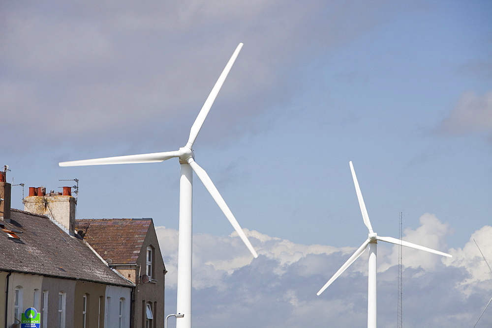 Wind turbines placed closed to housing on the outskirts of Workington, Cumbria, England, United Kingdom, Europe