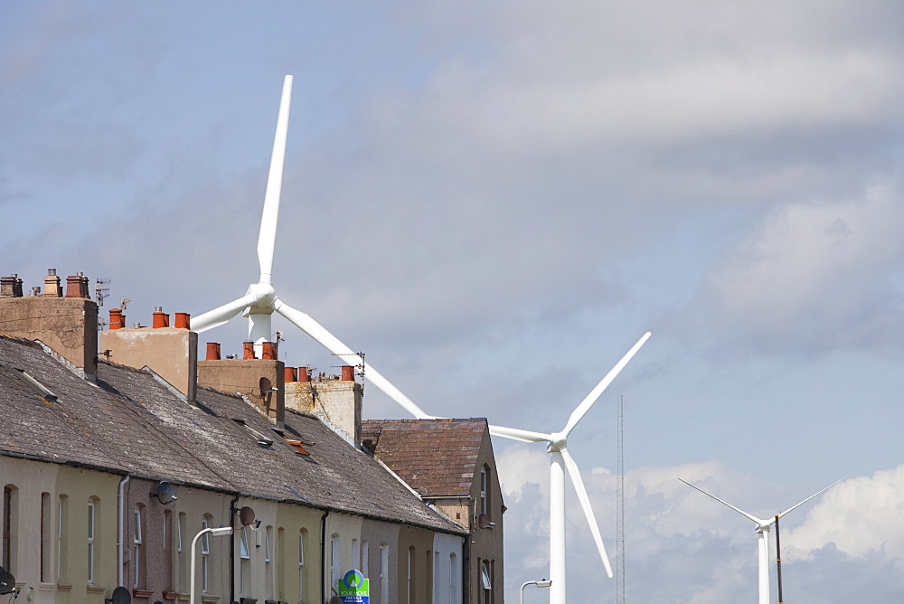 Wind turbines placed closed to housing on the outskirts of Workington, Cumbria, England, United Kingdom, Europe