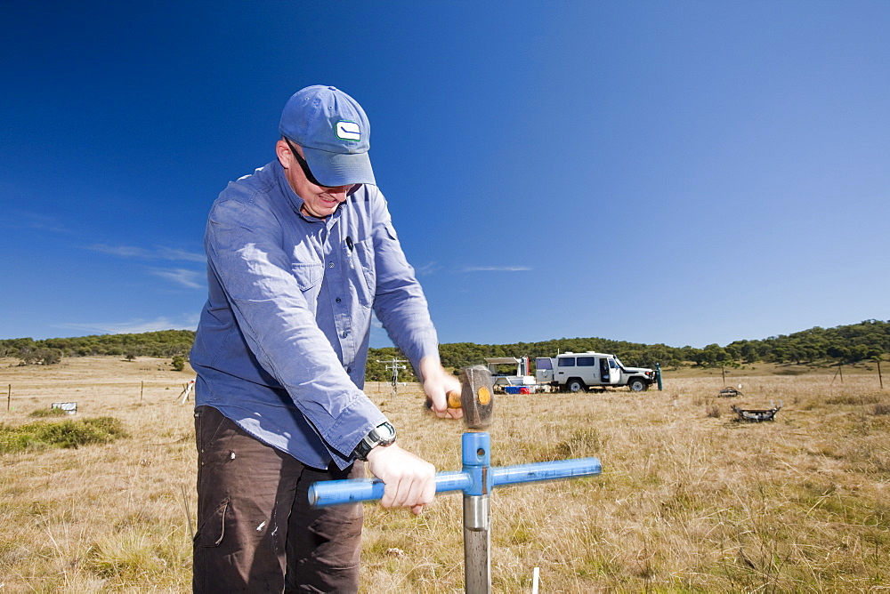 Robert Simpson takes soil samples to measure the level of methanotropic bacteria during an experiment by scientists from Sydney University, in the Snowy mountains, New South Wales, Australia Pacific