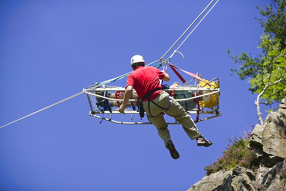 Members of Langdale Ambleside Mountain Rescue Team doing a stretcher lower down a crag in Langdale as part of training. Cumbria, England, United Kingdom, Europe