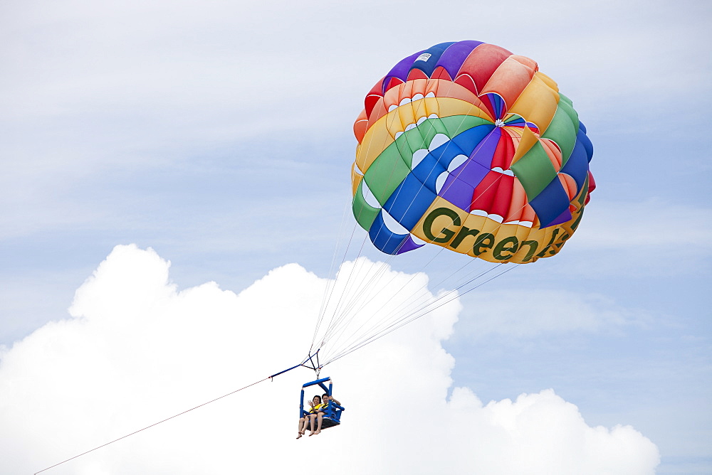 Tourists parasailing off Green Island on The Great Barrier Reef near Cairns in Queensland, Australia, Pacific