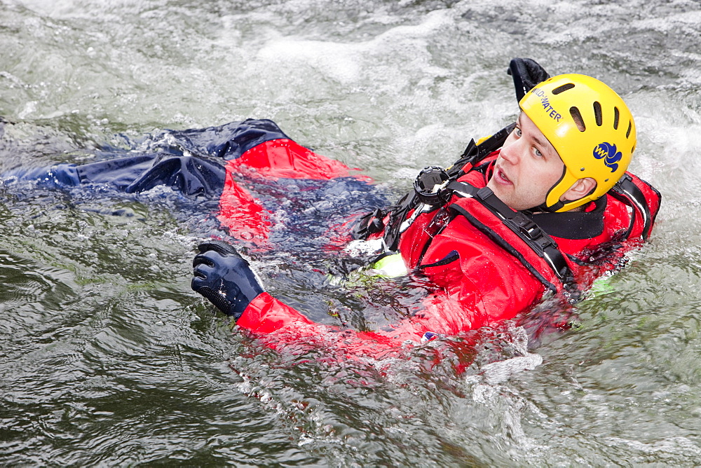 Members of the Langdale Ambleside Mountain Rescue Team train in Swift water rescue techniques on the River Brathay at Skelwyth, Lake District, Cumbria, England, United Kingdom, Europe