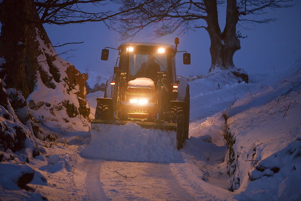 A farmer clearing snow from a lane near Ambleside, Lake District, Cumbria, England, United Kingdom, Europe