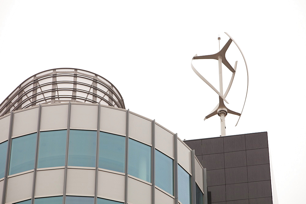 An urban wind turbine on the roof of The Peninsula, a new office development in Manchester, England, United Kingdom, Europe