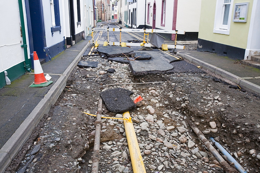 Gas main pipes revealed as the water ripped the tarmac off the road during the floods in November 2009, Cockermouth, Cumbria, England, United Kingdom, Europe