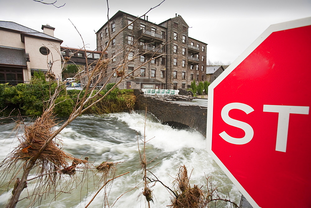 The flooding River Leven that empties Lake Windermere, swept the parapets off the bridge at Backbarrow, resulting in its closure, Cumbria, England, United Kingdom, Europe