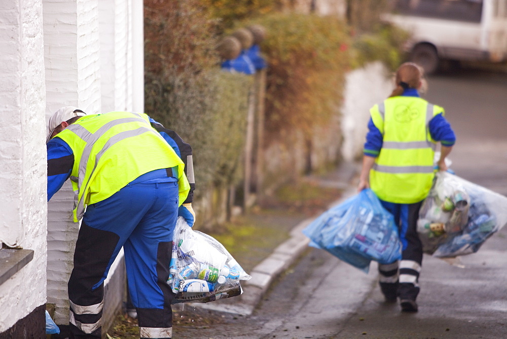 Council workers collecting bags of recycled rubbish in Polruan, Cornwall, England, United Kingdom, Europe