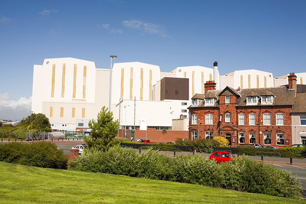 BAE systems buildings overshadowing old terraced houses in Barrow in Furness, Cumbria, England, United Kingdom, Europe