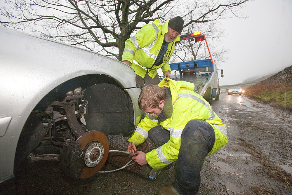 Car abandoned in the flood waters on Kirkstone Pass that subsequently had all its wheels stolen, above Ambleside, Cumbria, England, United Kingdom, Europe