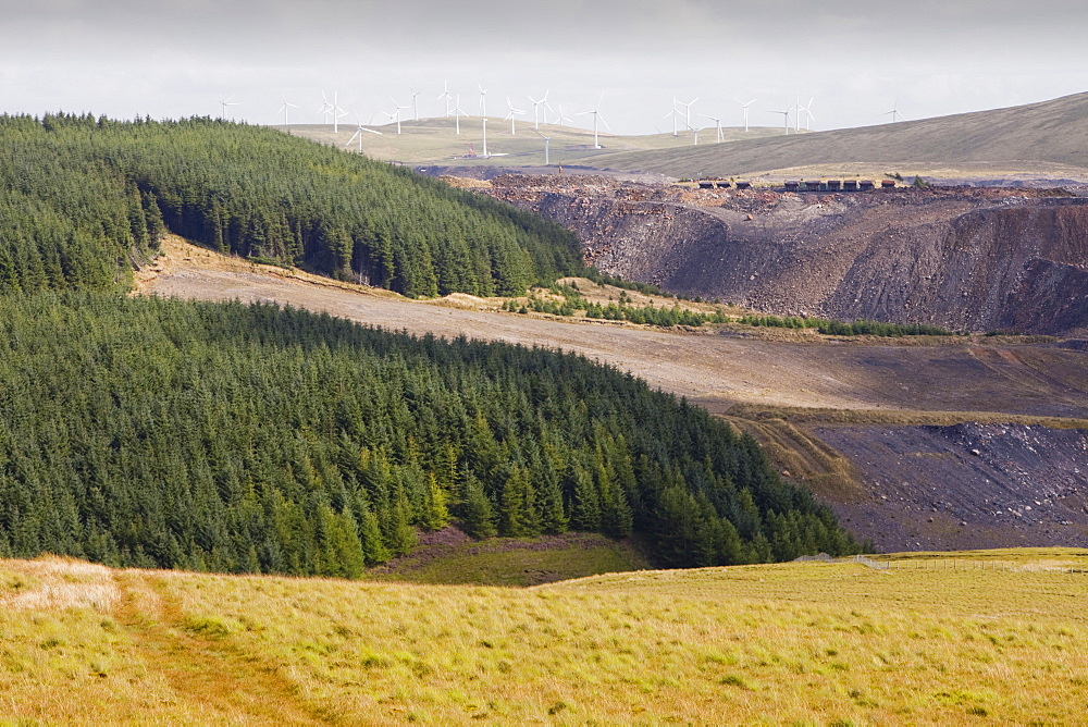 Climate change heaven and hell, showing The Hagshaw Hill wind farm above the Spireslack open cast coal mine in Lanarkshire, Scotland, United Kingdom, Europe