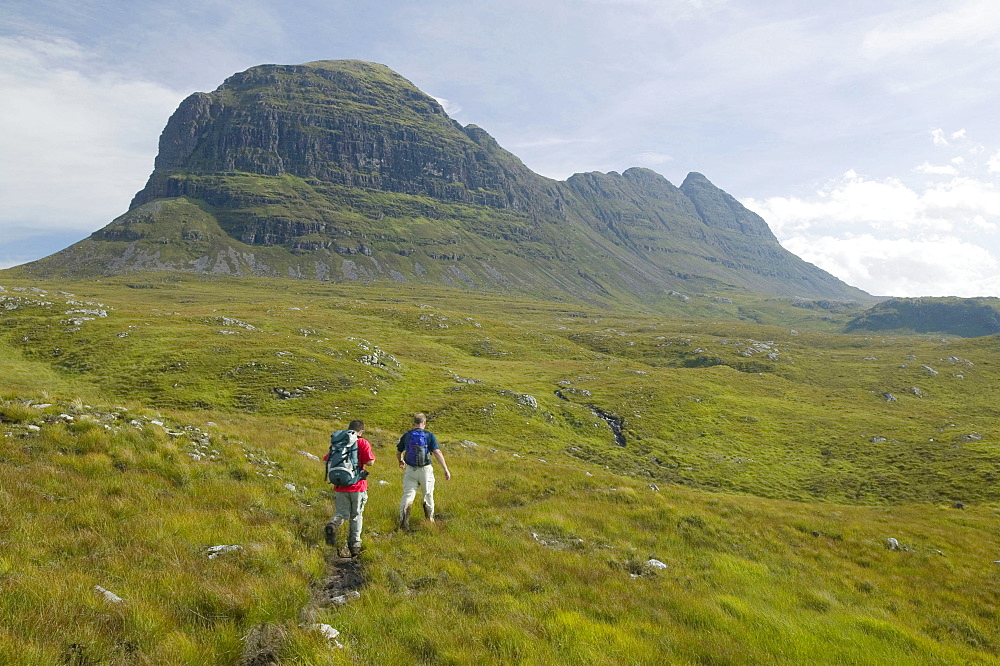 Walkers approaching Suilven mountain in Sutherland, Scotland, United Kingdom, Europe