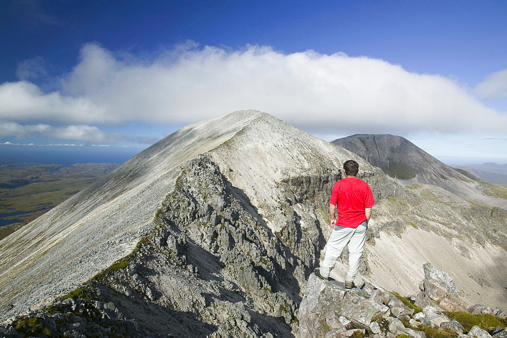 A walker on the peak of Foinaven in Sutherland, Scotland, United Kingdom, Europe