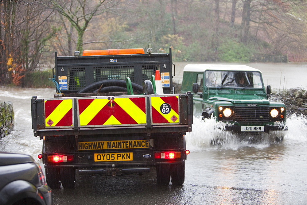 Vehicles struggling through the flooded roads in Ambleside, Lake District, Cumbria, United Kingdom, Europe