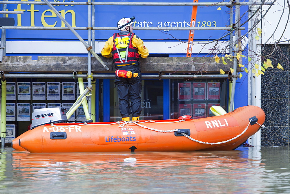 Rescue workers rescuing flood victims from their houses on the Main Street of Cockermouth, Cumbria, England, United Kingdom, Europe