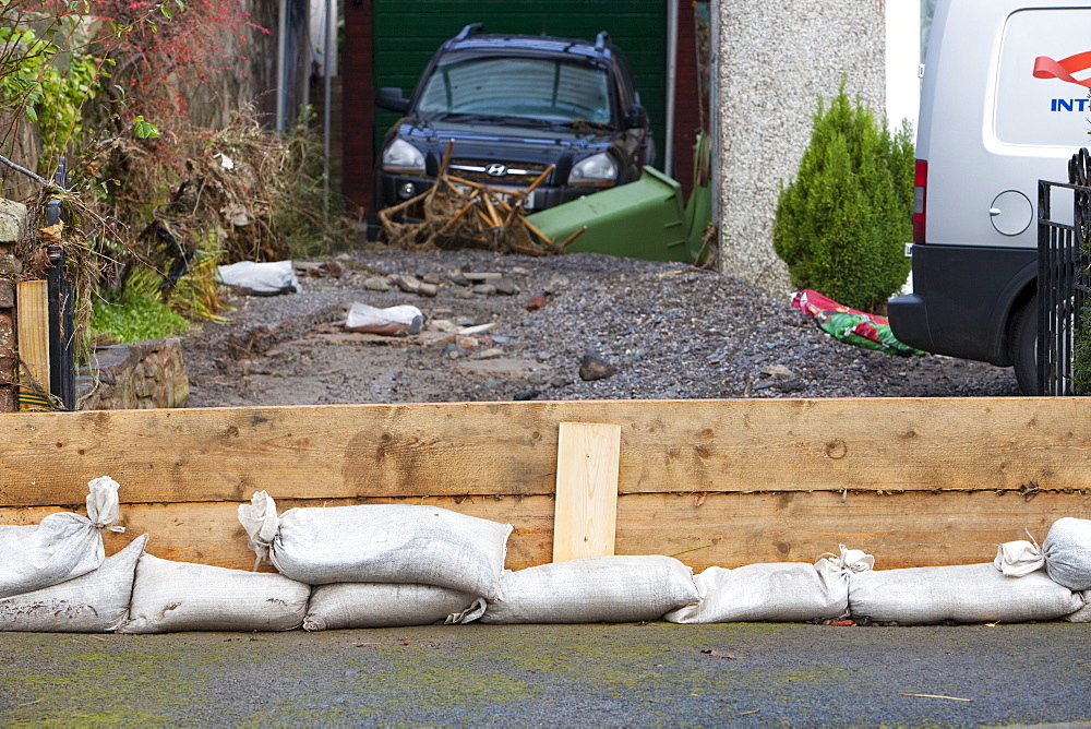 A householder's attempt to hold bavk the flood waters near Cockermouth's Main street, after the water receded, Cumbria, England, United Kingdom, Europe