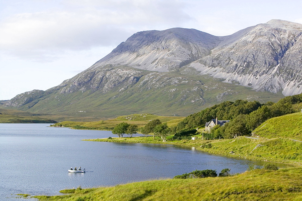 Fishermen on Loch Stack beneath the peak of Arkle in Sutherland, Scotland, United Kingdom, Europe