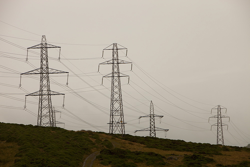 Electricity pylons traversing Bwlch Y Ddeufaen on the edge of the Snowdonia Mountains, North Wales, United Kingdom, Europe