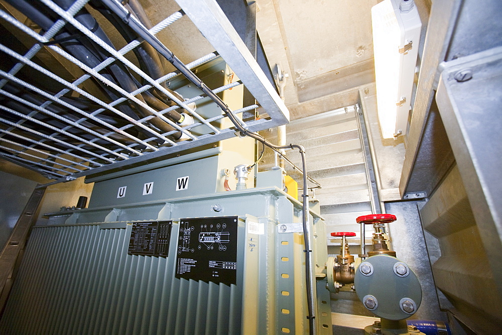 An electrical transformer inside an offshore wind turbine, destined for the Walney offshore wind farm, Mostyn, North Wales, Wales, United Kingdom, Europe