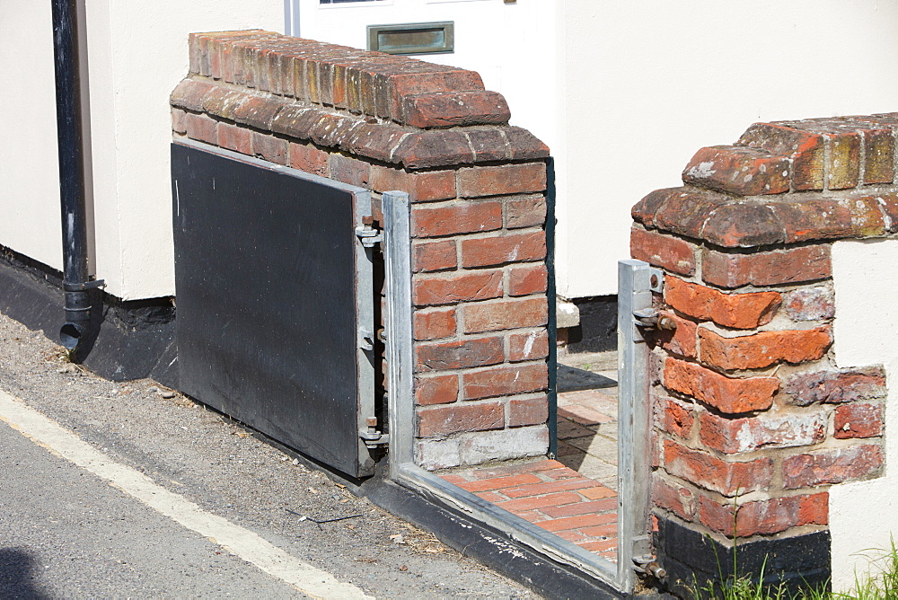 A house in Wells Next the Sea with a flood gate to protect against storm surge coastal flooding, Norfolk, England, United Kingdom, Europe