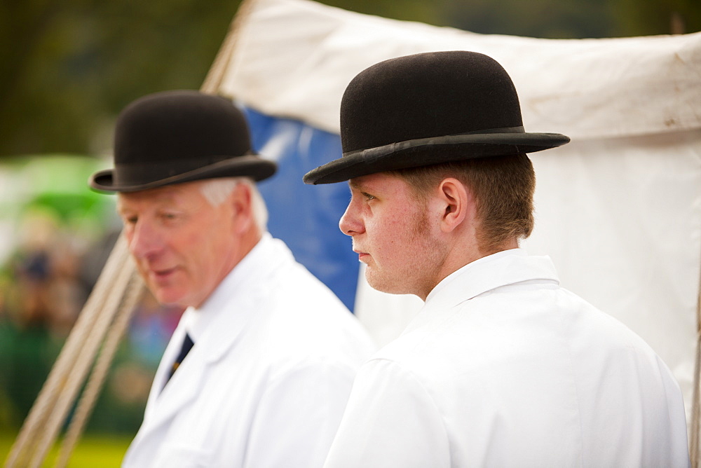 Men wearing the bowler hats and white coats traditionally associated with Beagle dog shows, at the Vale of Rydal Sheepdog Trials, Ambleside, Lake District, Cumbria, England, United Kingdom, Europe