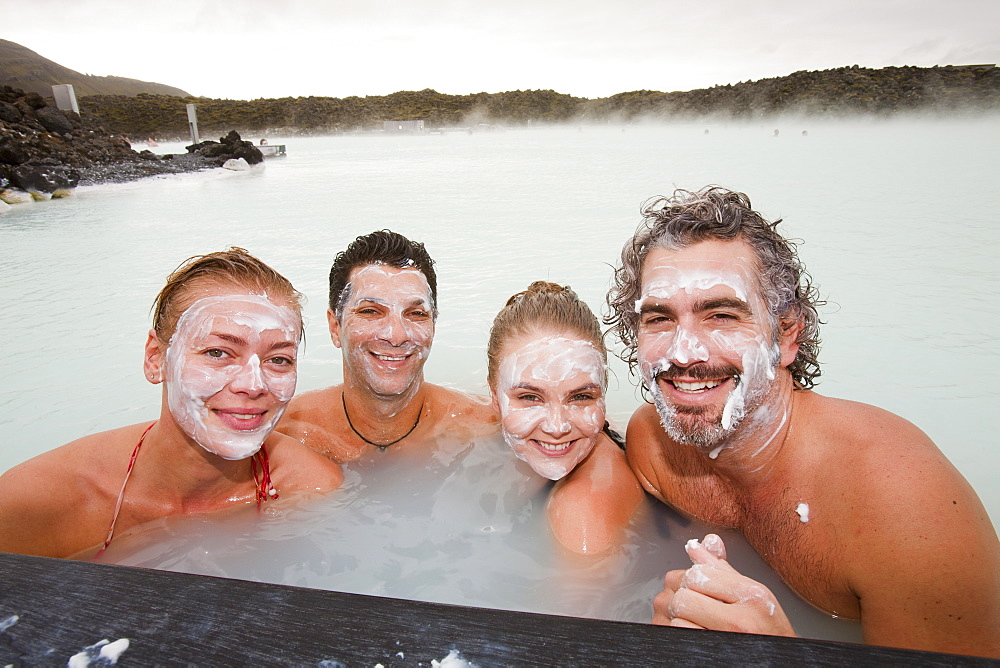 Four friends relax at the Blue Lagoon near at Keflavik in Iceland, Polar Regions