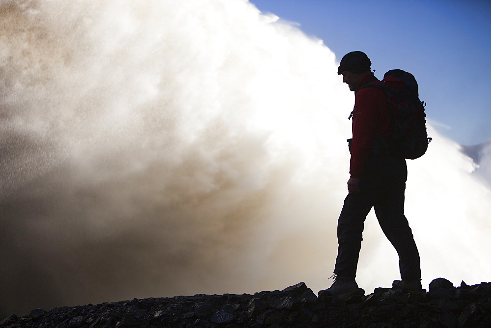 Mountaineer by the overspill from the Karahnjukar dam and Halslon reservoir, North East Iceland, Iceland, Polar Regions