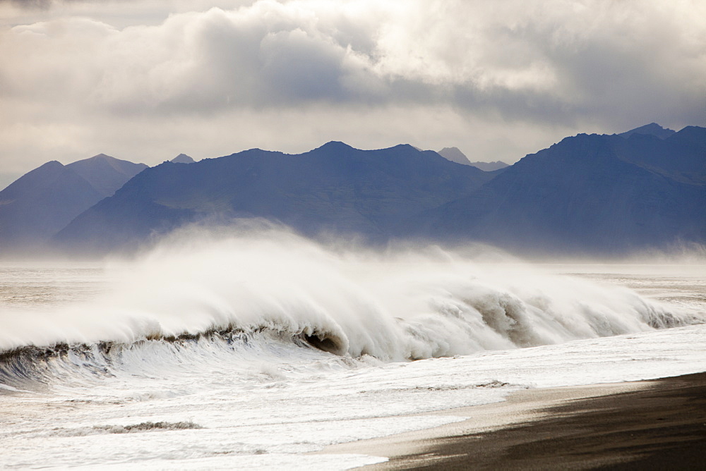 Storm force winds blowing spray off the sea in Hamarsfjordur on Icelands South Coast, Iceland, Polar Regions