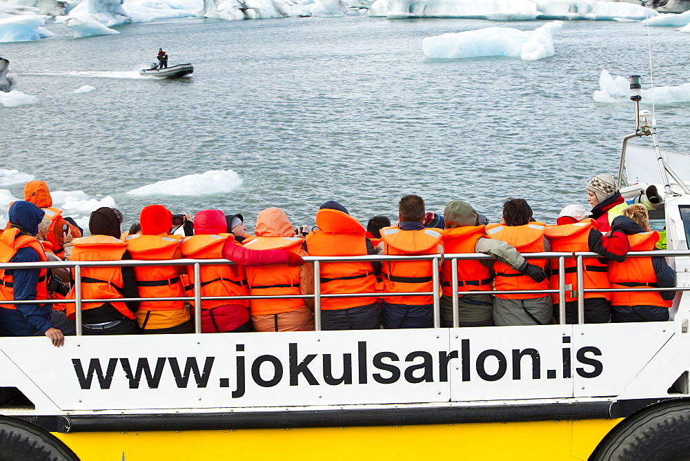 Tourists riding in an amphibious truck at the Jokulsarlon ice lagoon, one of the most visited places in Iceland, Polar Regions