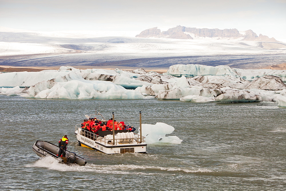 Tourists taking a boat trip to get close to the icebergs, Jokulsarlon ice lagoon, one of the most visited places in Iceland, Polar Regions