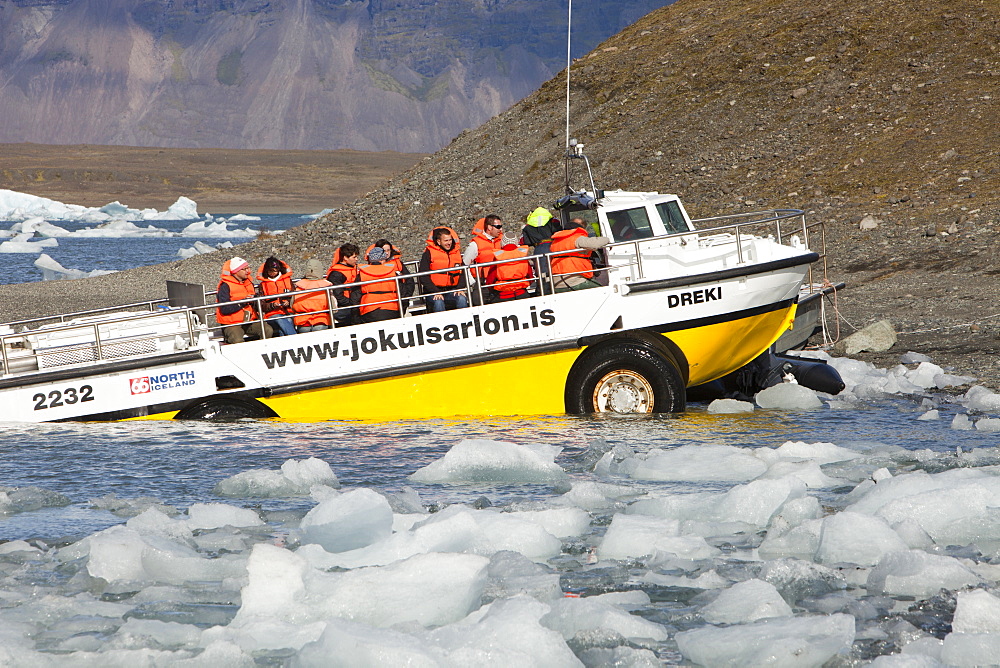 An amphibious vehicle taking tourists on a trip at the Jokulsarlon ice lagoon which is one of the most visited places in Iceland, Polar Regions