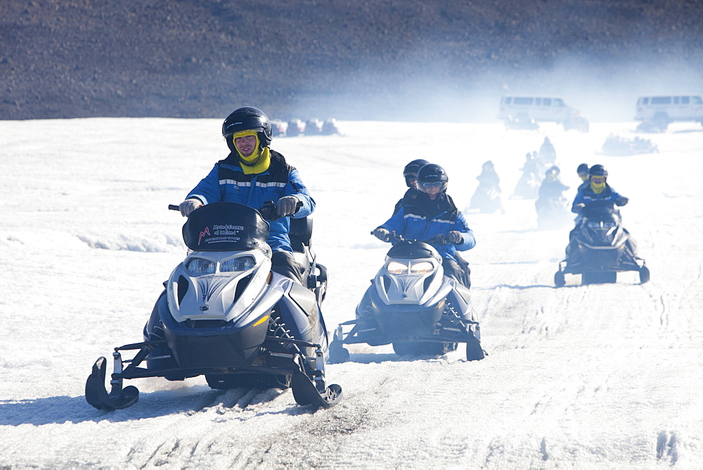 Tourists riding through a stinking fog of exhaust fumes from skidoos on the Langjokull ice sheet in Iceland, Polar Regions