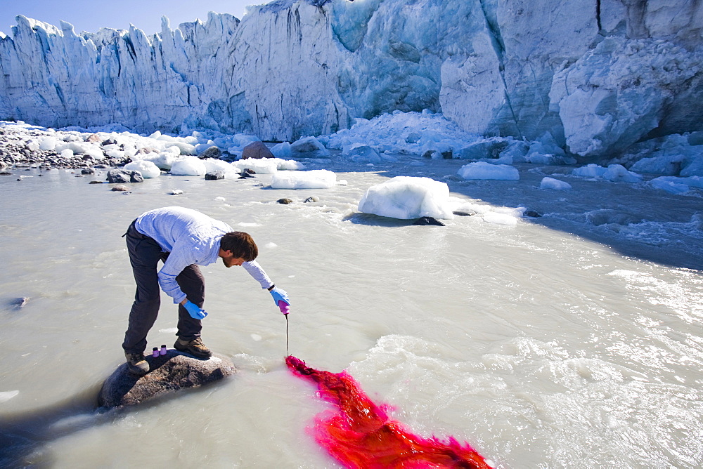 PHD scientist Ian Bartholomew using dye tracing techniques as part of a study to measure the speed of the Russell Glacier near Kangerlussuaq, Greenland, Polar Regions