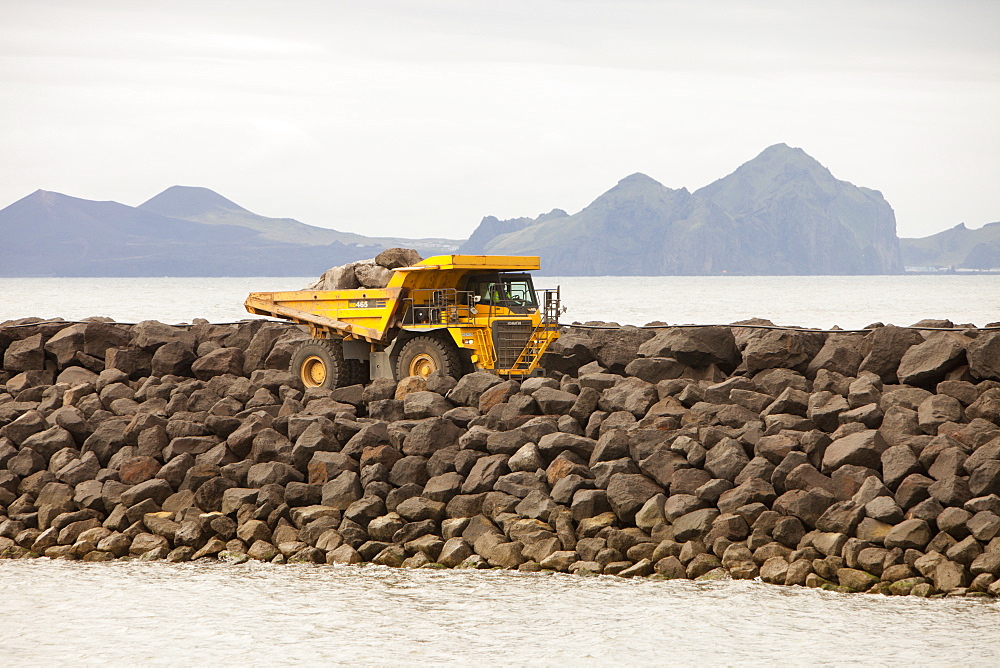 Building a new harbour for the ferry to the Westman Islands, seen in the background, on the south coast, Iceland, Polar Regions