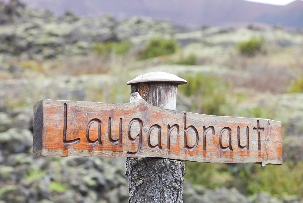 A signpost naming the street buried underneath the lava flow at this point in Heimaey, Iceland, Polar Regions