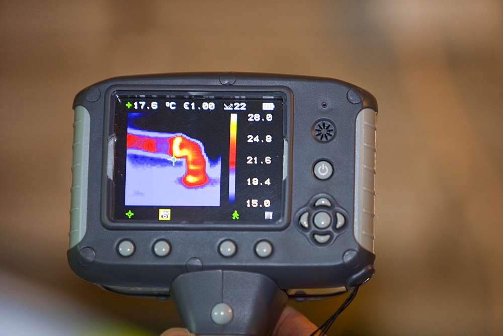 A thermal imaging camera shows heat loss from a hot water pipe, United Kingdom, Europe